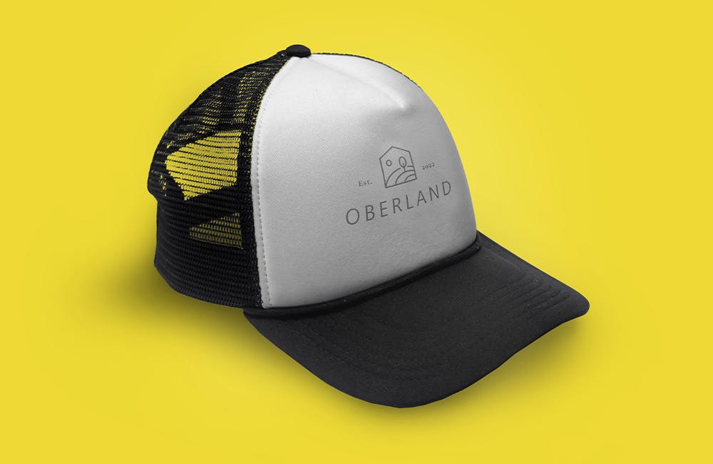 Black and white trucker hat on yellow background