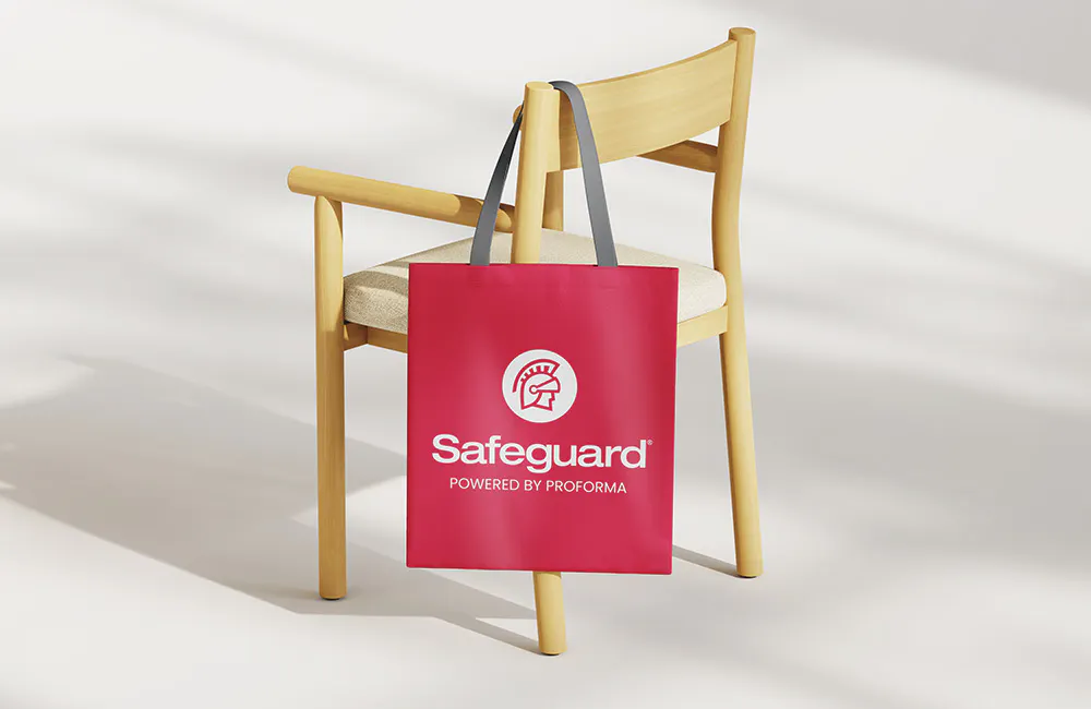 red safeguard branded tote bag hanging on a chair