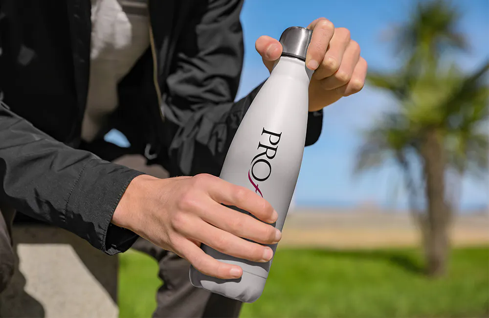 man holding white Proforma branded metal water bottle