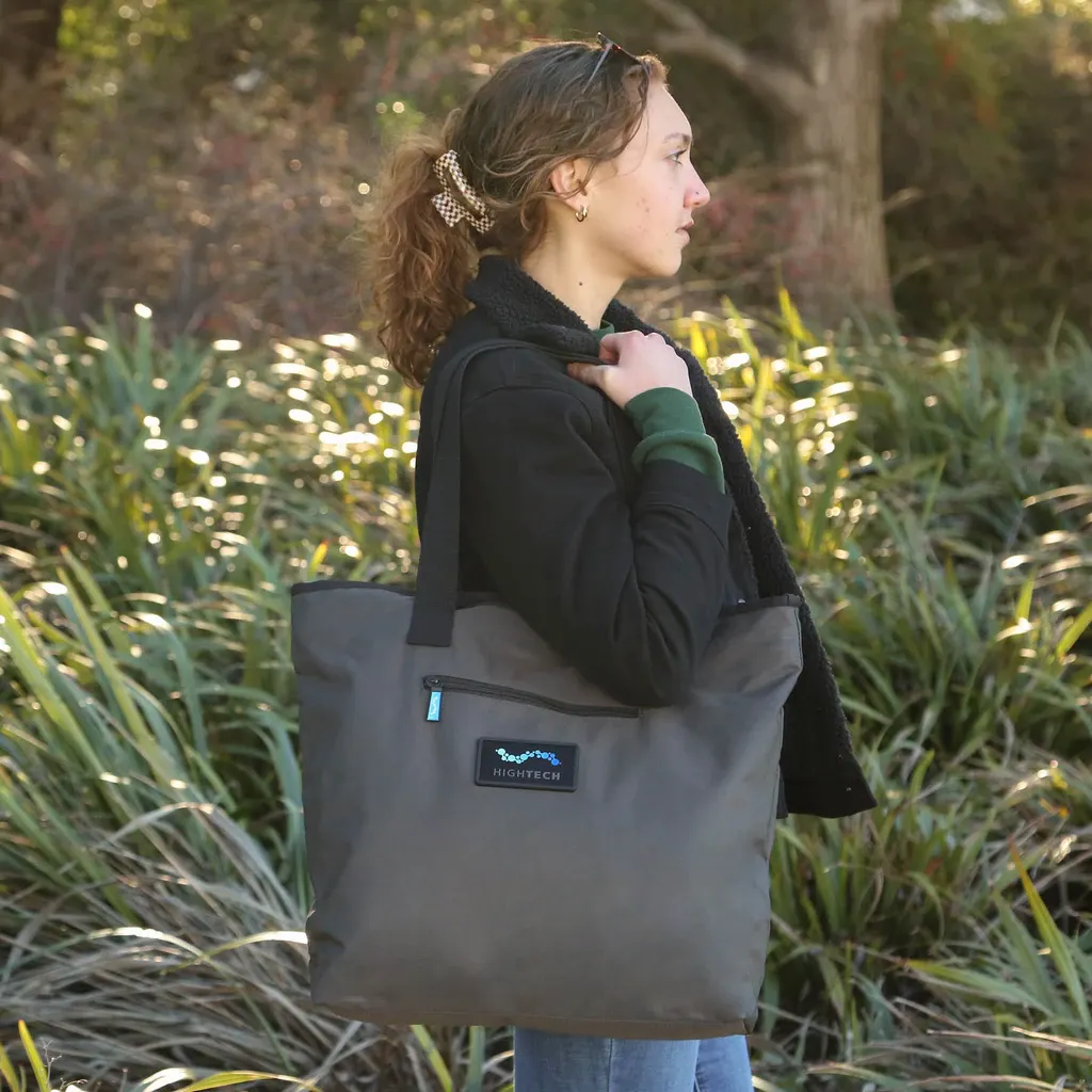 person walking with a tote bag