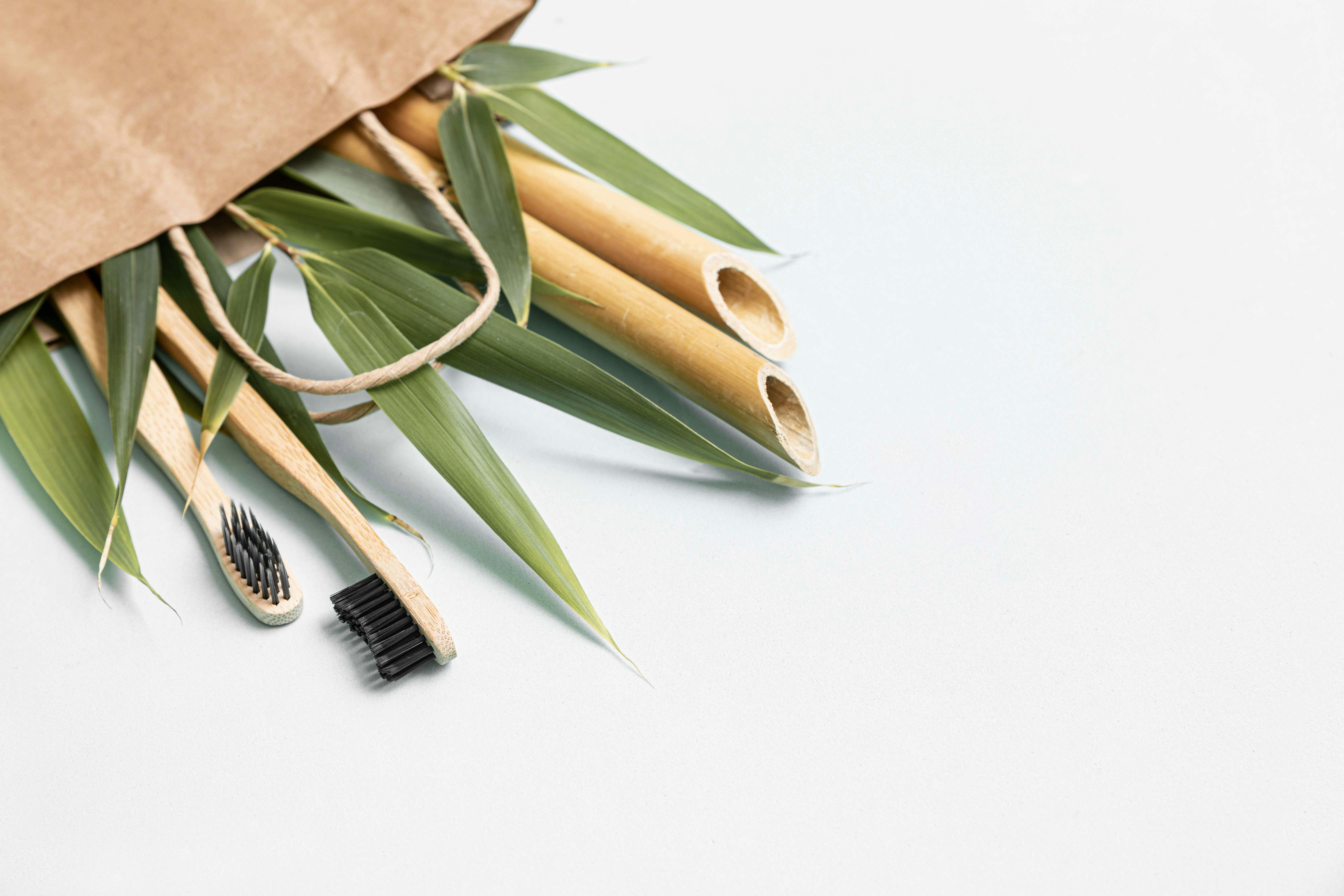 Bamboo toothbrush and eco bag on a table with copy space on a white background