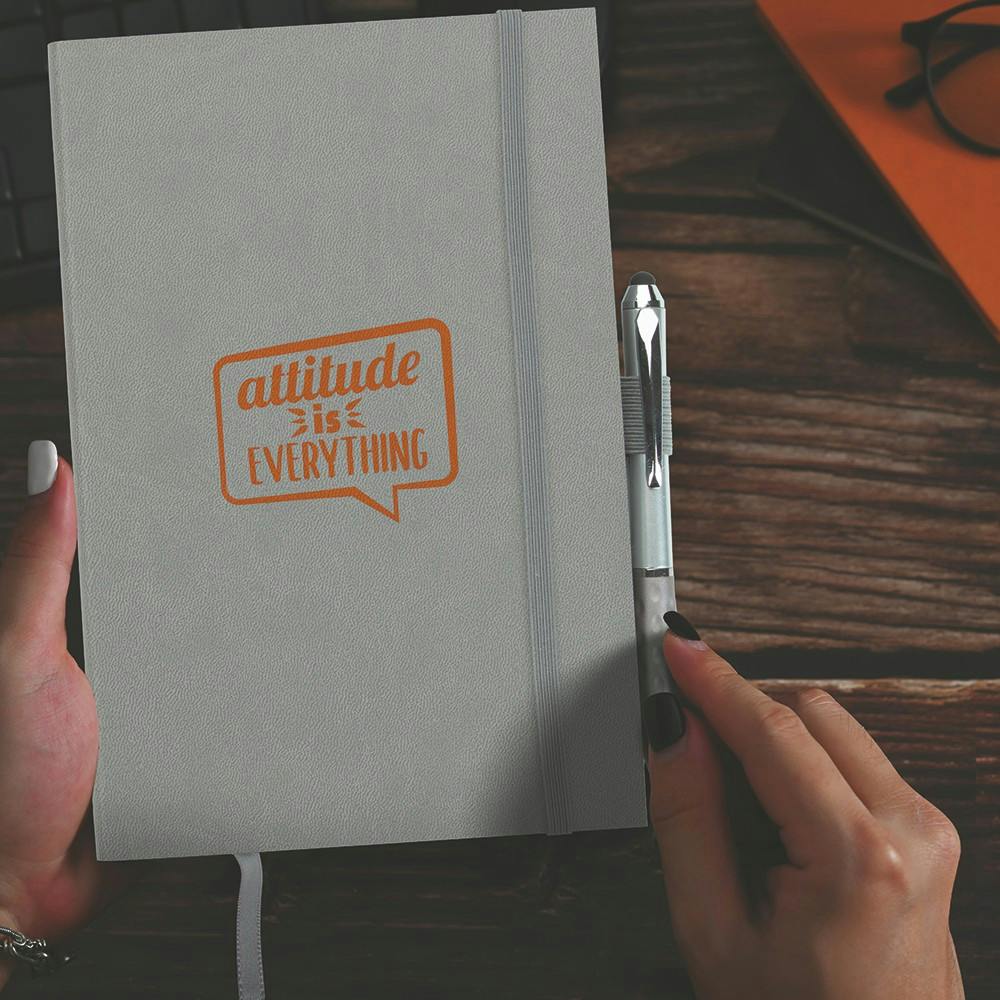 gray notebook and pen