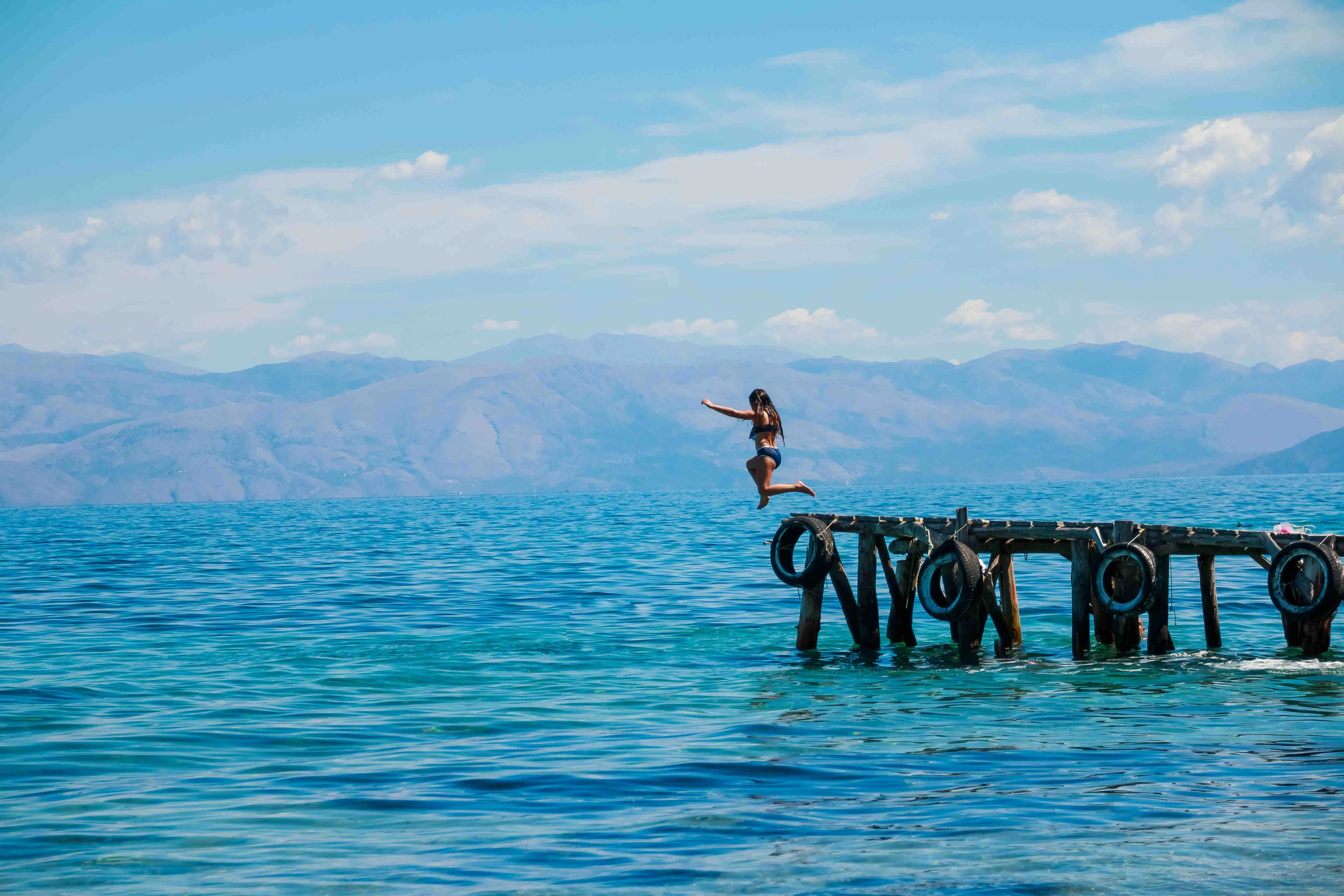 Girl Jumping Off A Pier