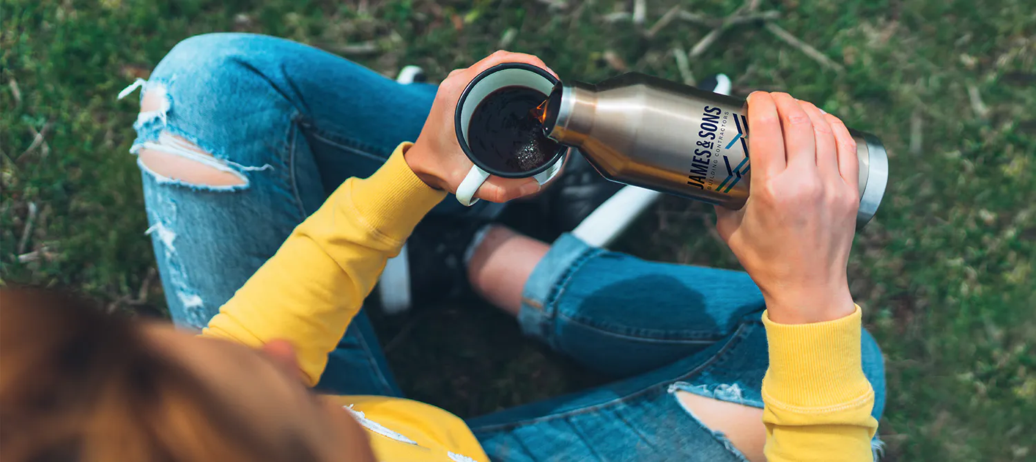 woman pouring coffee from a thermos