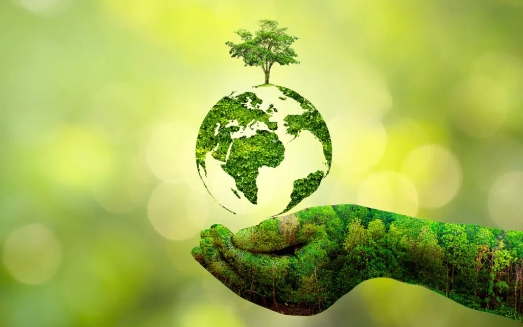Hand with globe protecting planet