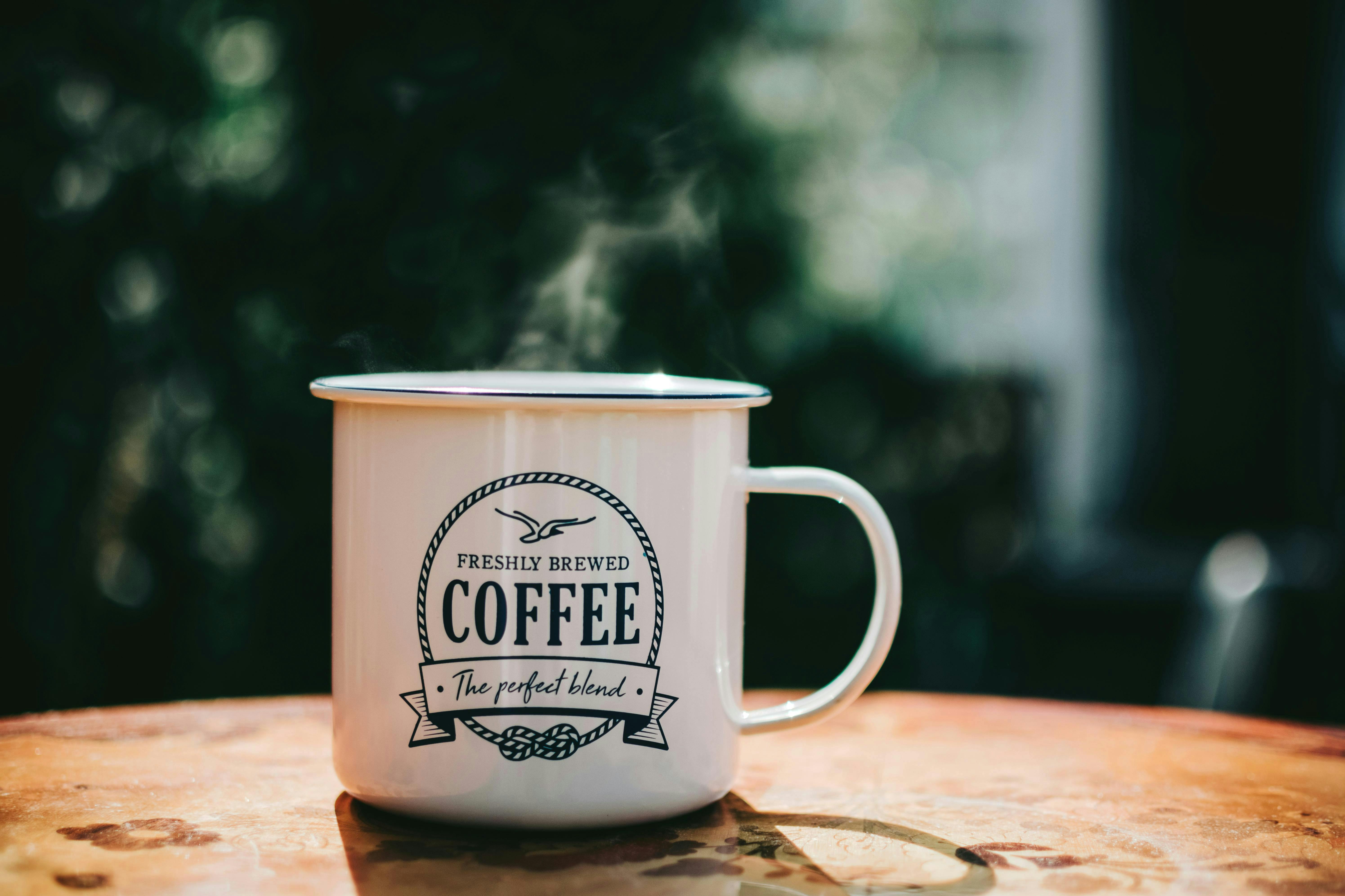 white coffee mug with text that reads Freshly Brewed Coffee The Perfect Blend