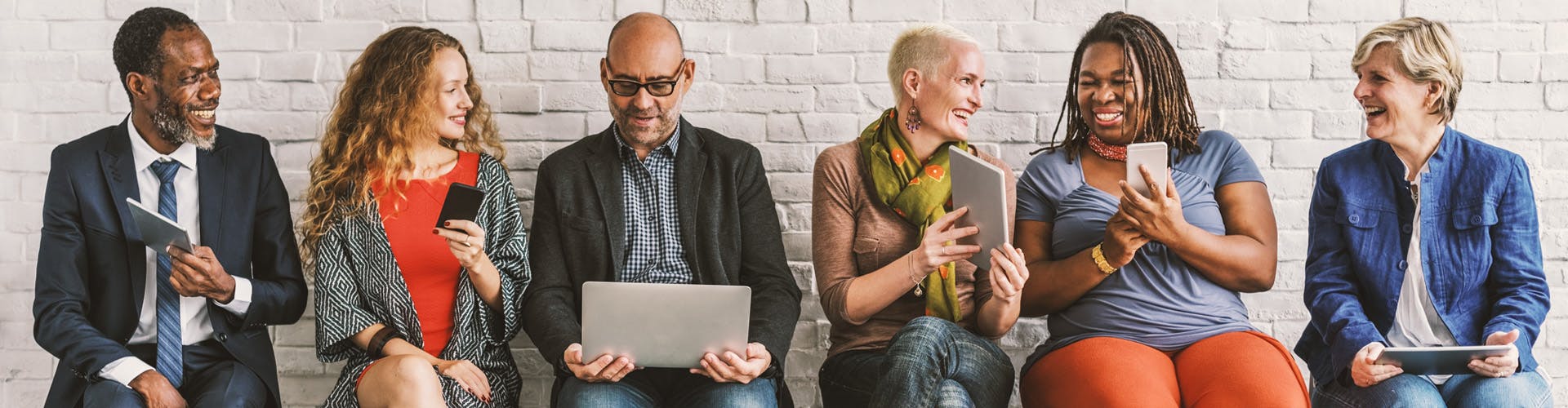 diverse office setting with people working on computers and phones