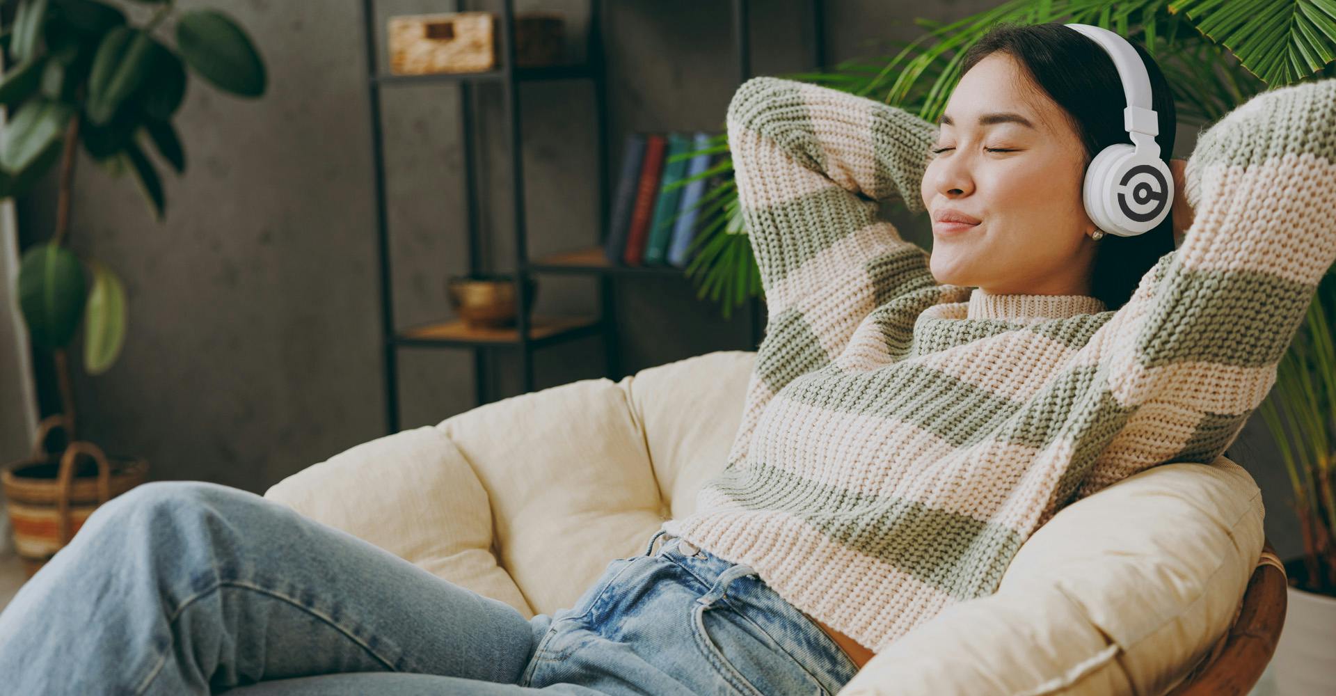 woman lounging in living room with headphones