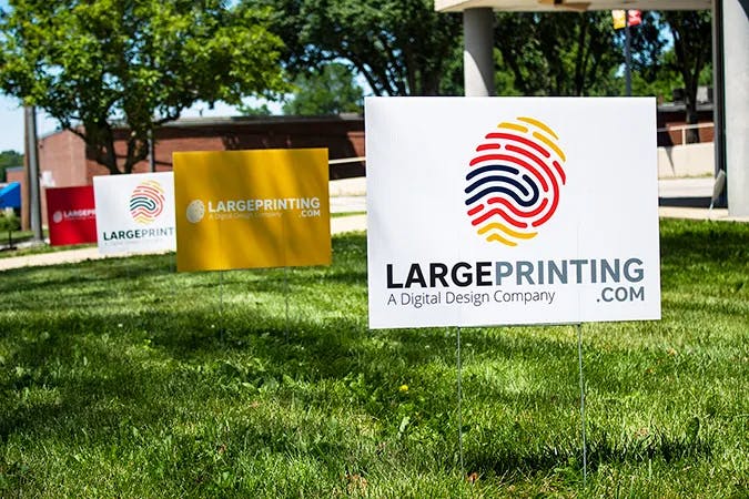 white yard sign with multicolor fingerprint logo