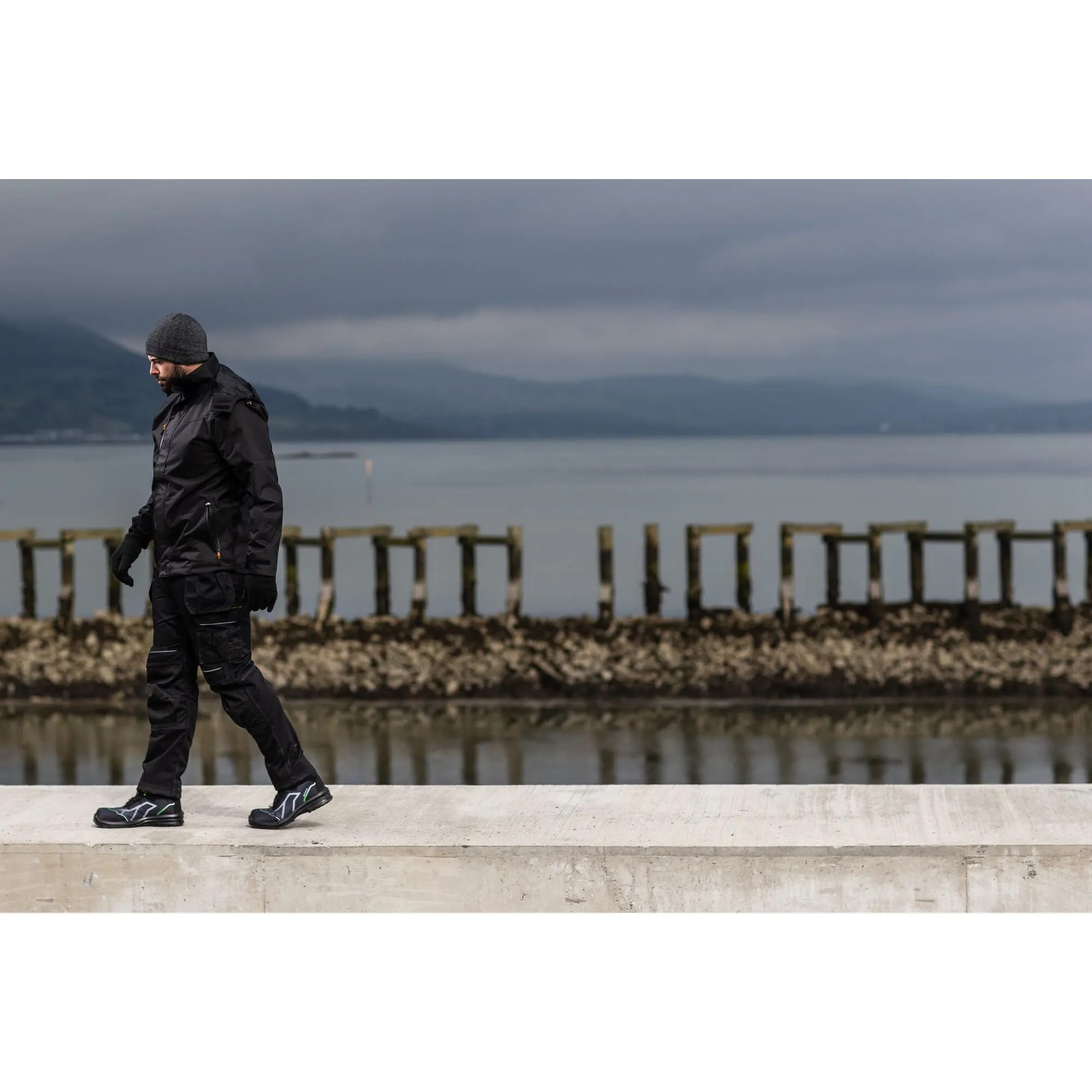 Man walking in warm Portwest outfit next to the ocean