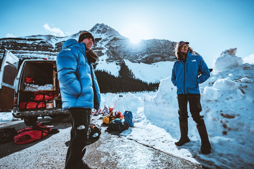 two men in snow with The North Face jackets