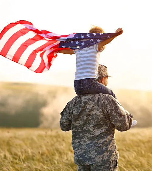madeinusa2 child on shoulders of soldier while holding an american flag