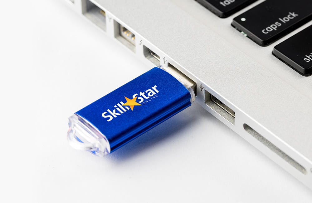 blue USB drive plugged into a laptop