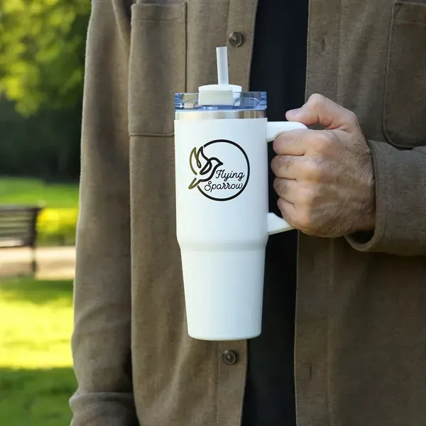 holding travel mug