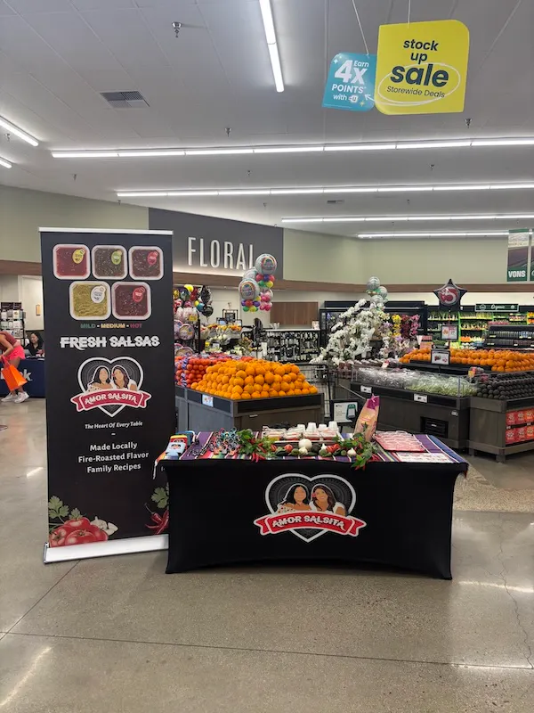 Custom retail activation setup including retractable banner and branded table display for instore pr