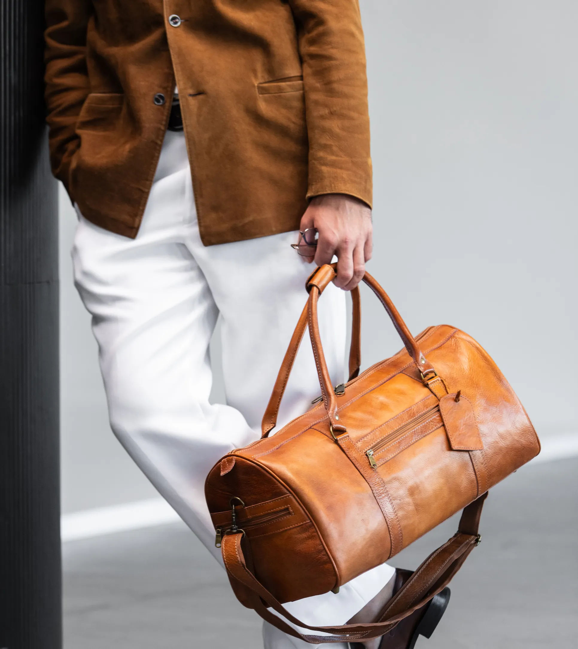 Man holding leather bag