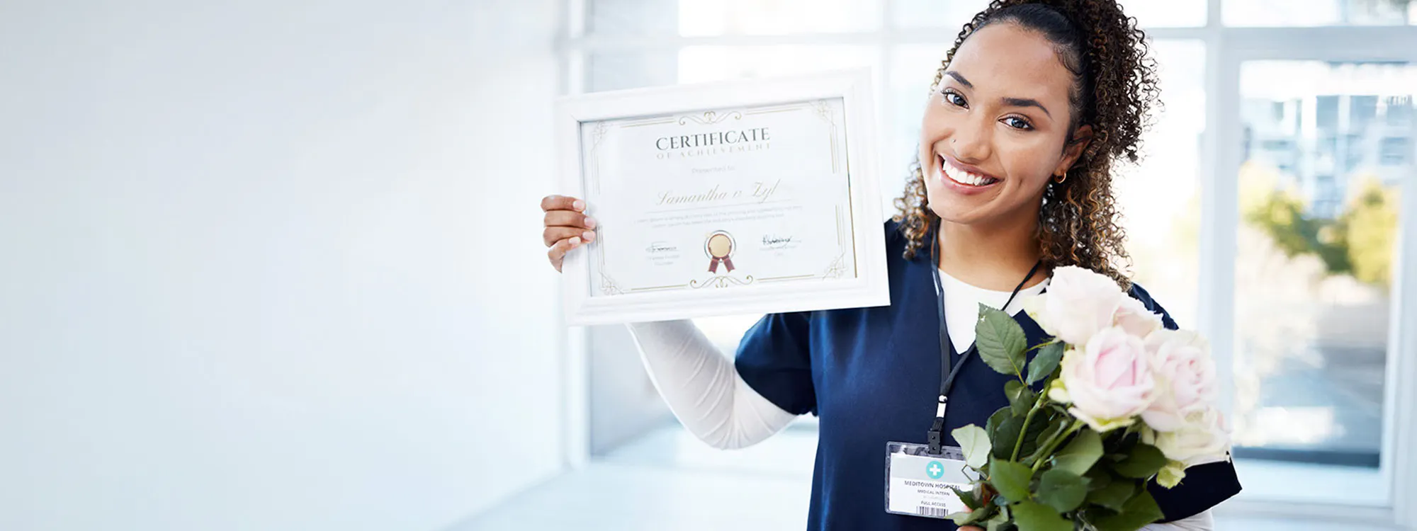 young woman holding Certificate of Achievement and flowers