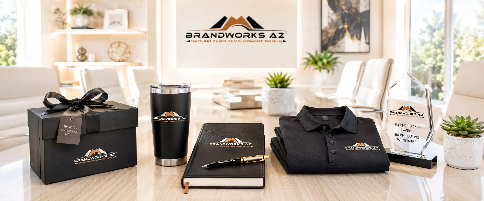 Premium branded promotional products displayed in a bright executive office with apparel, gifts, and corporate awards.