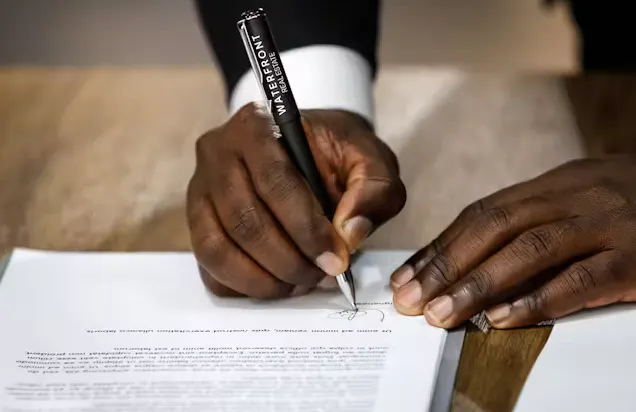 person writing with a pen