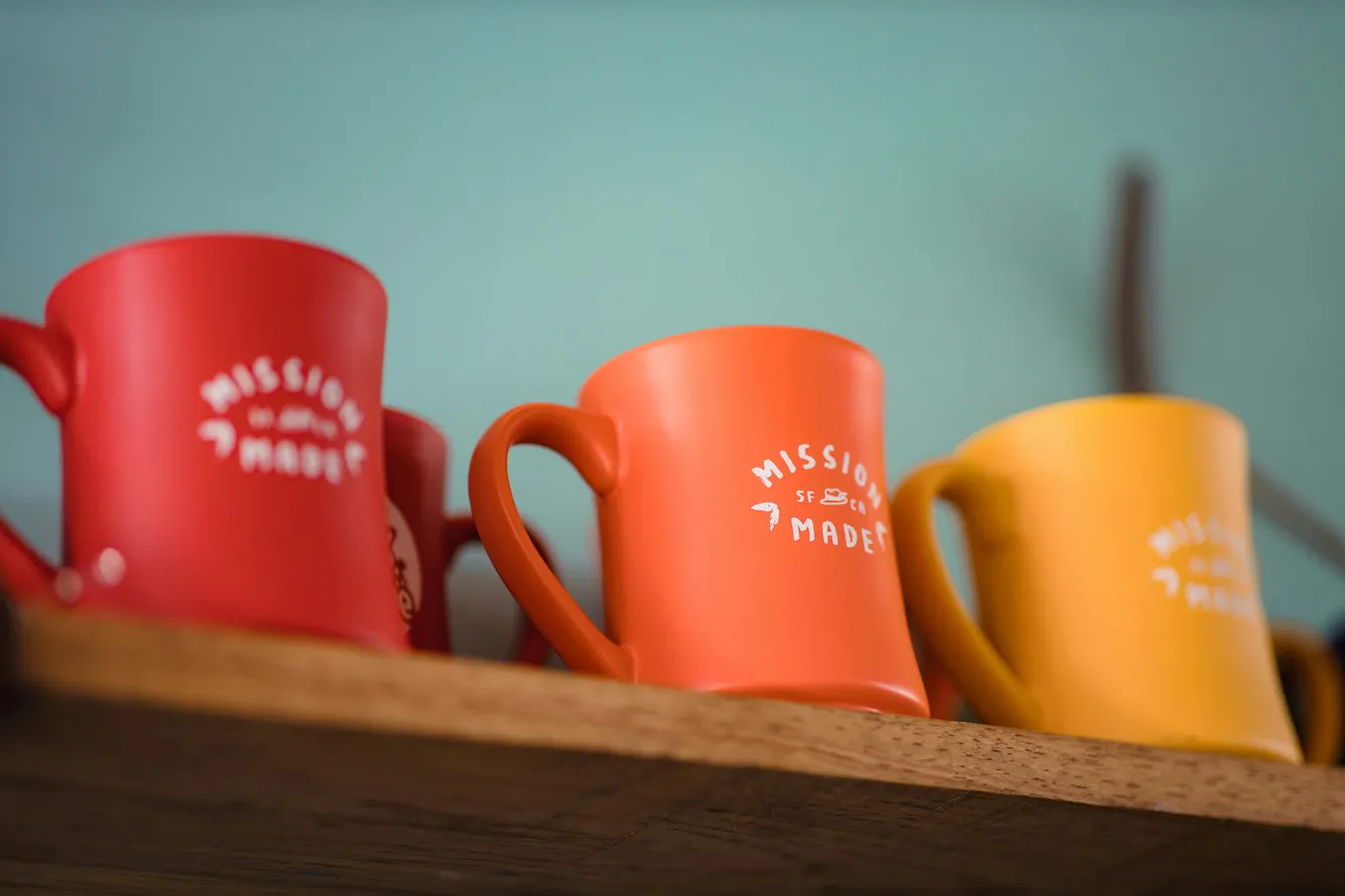 colorful branded mugs on a shelf 