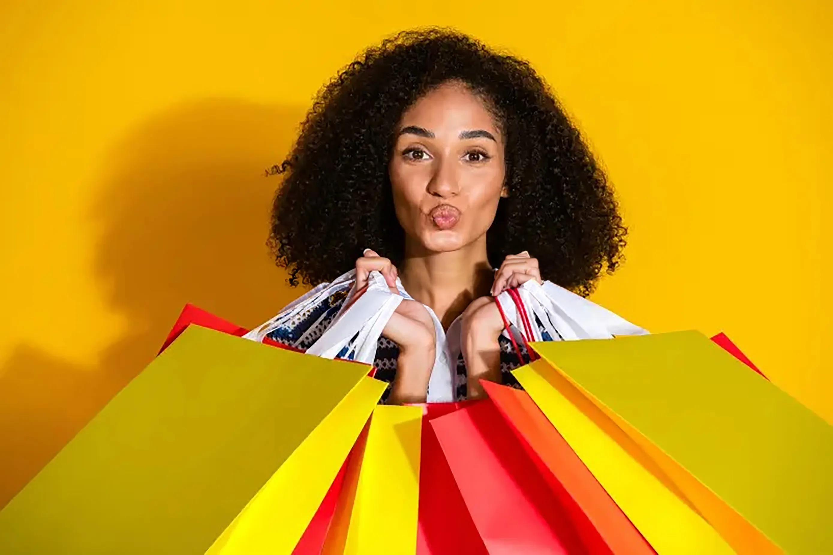 Two people wearing red and coral sweatshirts on a blue background 