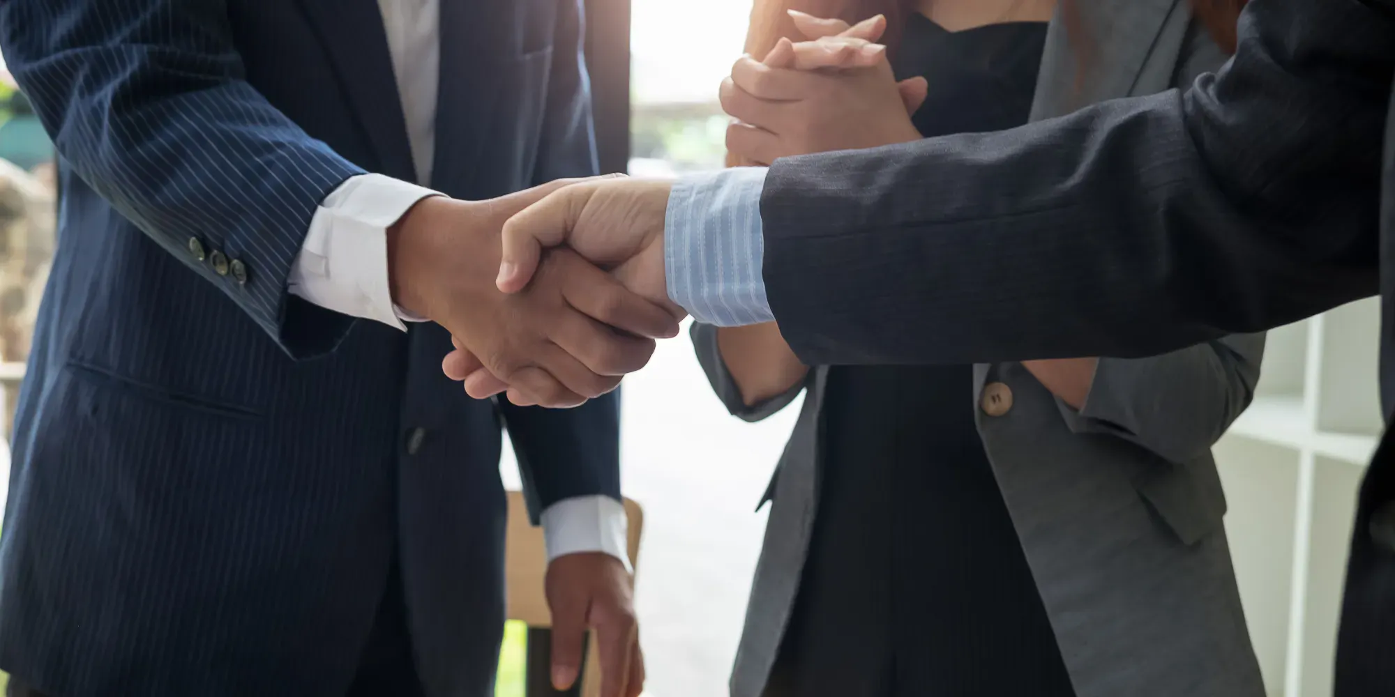 coworkers handshake business deal