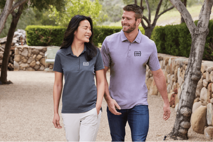 Man and Woman wearing polos walking down a pathway