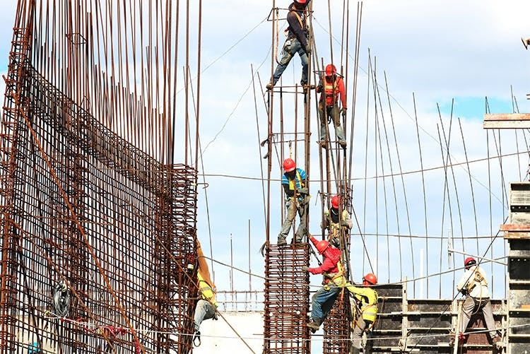 Construction builders on rebar