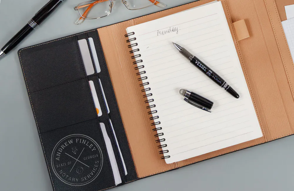 notebook and pen in padfolio