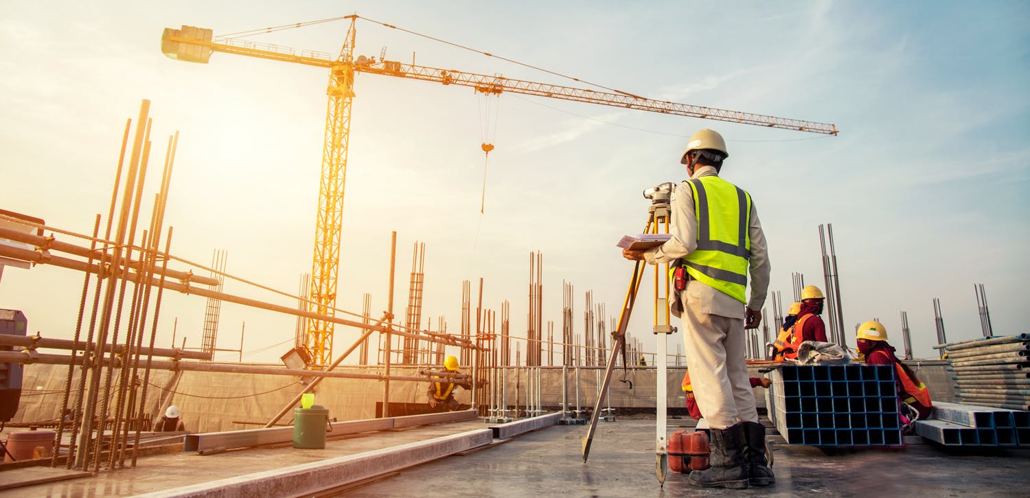 Man on construction site in full gear.