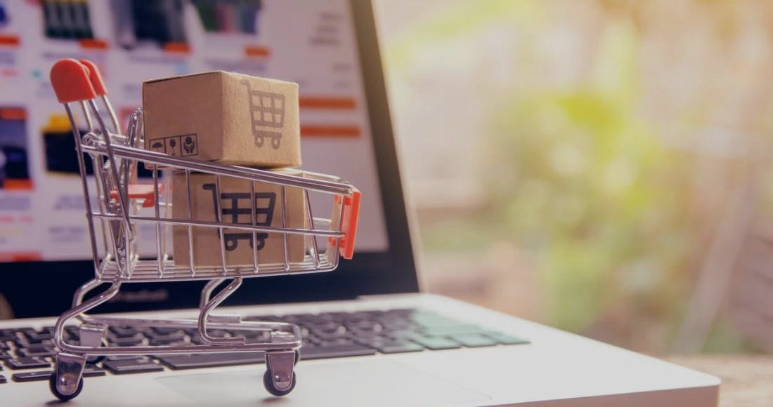 online shopping cart on top of computer