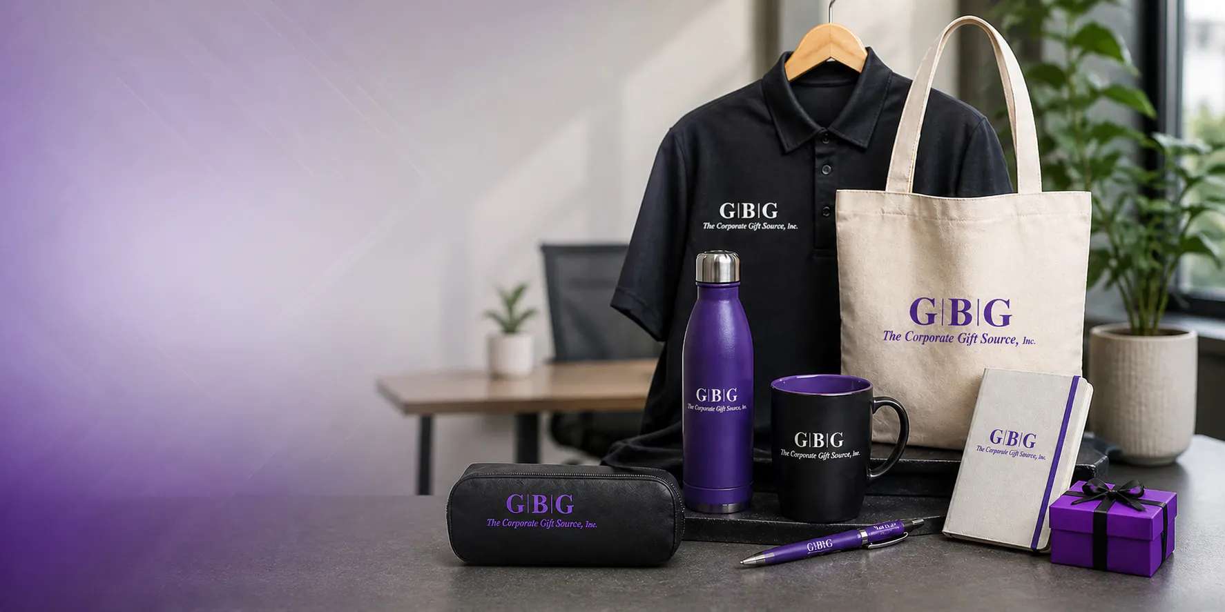 Branded corporate merchandise including logo polo, tote bag, water bottle, mug, notebook, and accessories displayed on a