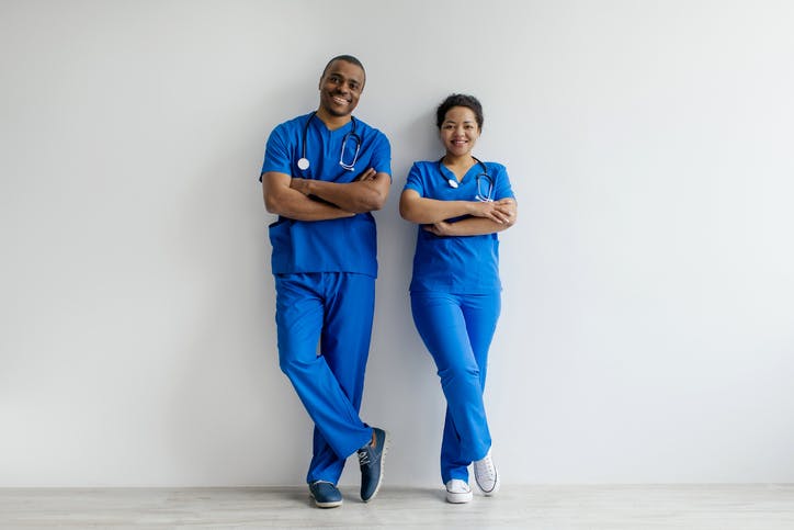 two people wearing blue scrubs