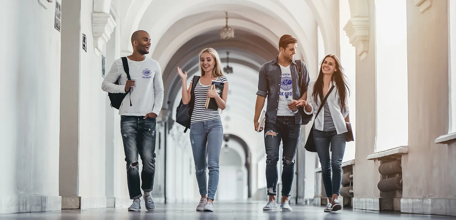 college students walking to class wearing shirts with school logo imprinted